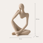 Abstract Seated Figure Sculpture in a warm desk setup