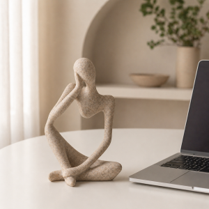Abstract Seated Figure Sculpture in a warm desk setup