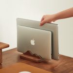Adjustable Walnut Vertical Laptop Stand in a warm desk setup