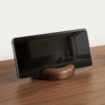 Round Walnut Phone Stand in a warm desk setup